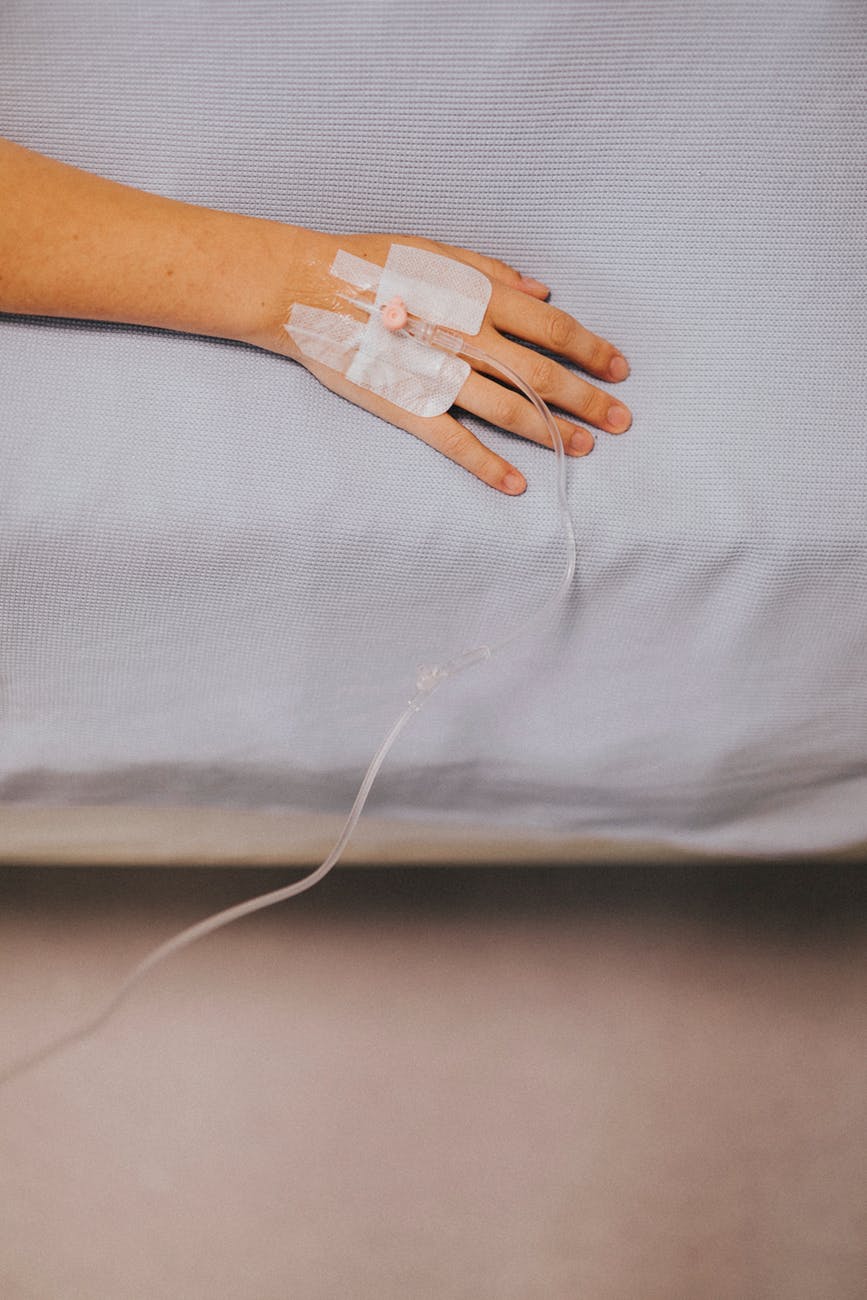 intravenous hose on person s hand